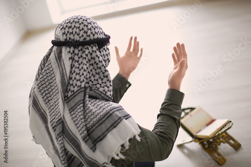 Young Muslim man praying, i...