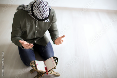 Young Muslim man praying, i...