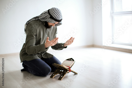 Young Muslim man praying, i...