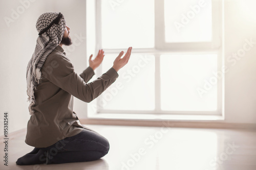 Young Muslim man praying, i...