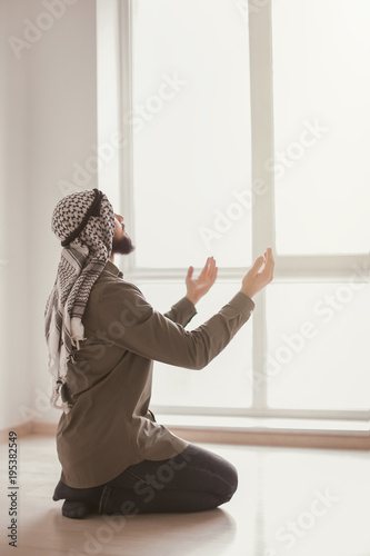Young Muslim man praying, i...