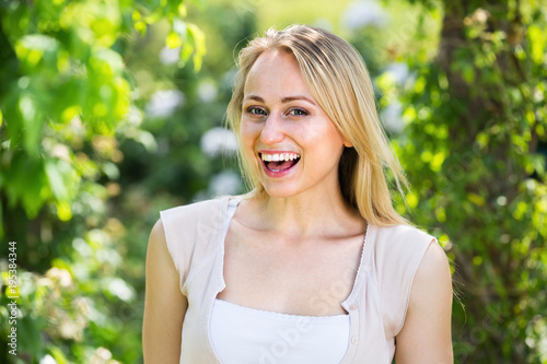 сloseup of merry young woman standing outdoors