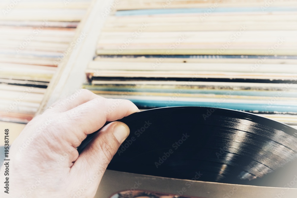 Obraz premium hands choosing vinyl records