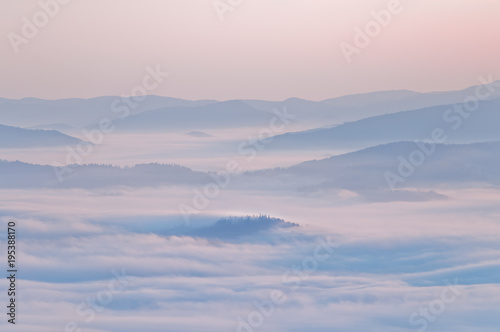 Summer mountain landscape with the sea fog