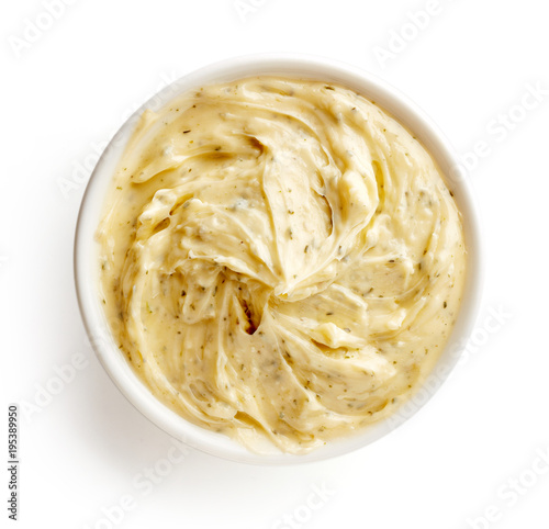 Bowl of herbal butter isolated on white, from above