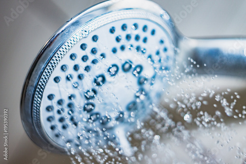 shower head with drops of water falling down
