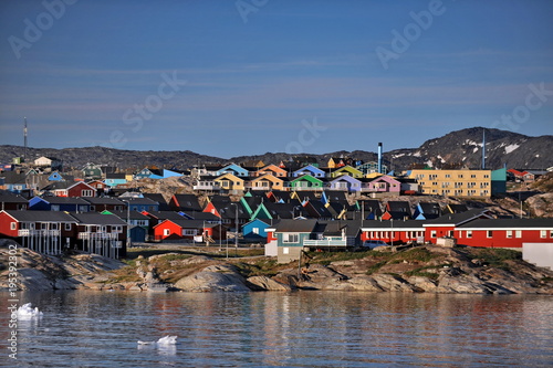 Greenland. The picturesque village of Ilulissat is comfortably located near a beautiful glacier photo