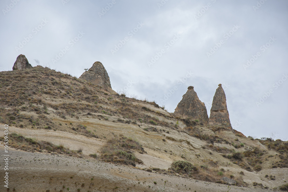 Fairy chimneys in Cappadocia . The fairy chimney is a product of its many environments, a miracle millions of years in the making.