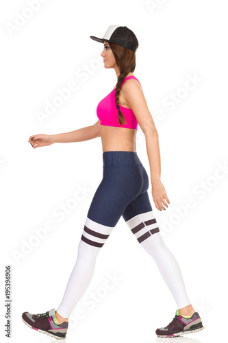 Beautiful Young Woman In Sports Clothes Is Walking. Side View.