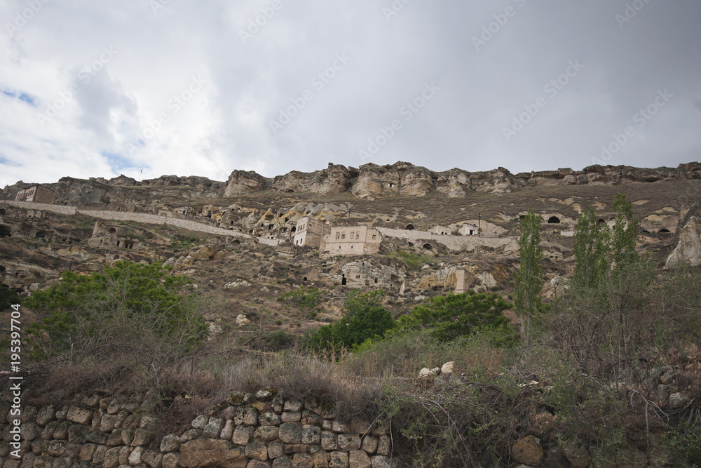 Badlands and old stone houses in Cappadocia
