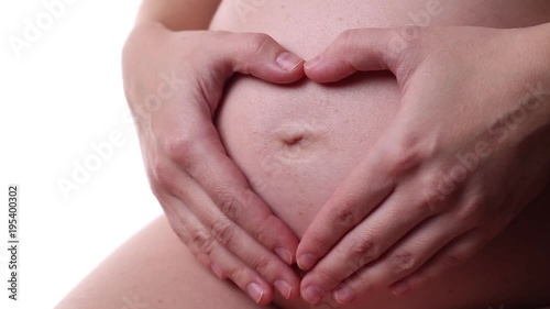 Wallpaper Mural A pregnant woman makes a heart shape with her fingers on her stomach Torontodigital.ca
