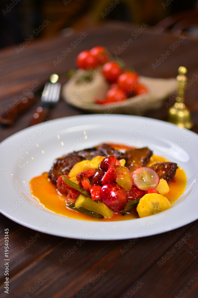 Tasty dish on a wooden table of a italian restaurant. Italian food photo background with vertical orientation. Tasty dish on a wooden table of a italian restaurant. Italian food photo background with vertical orientation.