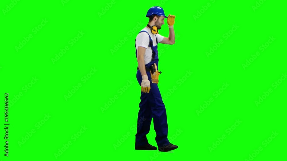 Builder walks and waves to his workers, showing a thumbs-up. Green screen. Side view Builder walks and waves to his workers, showing a thumbs-up. Green screen. Side view