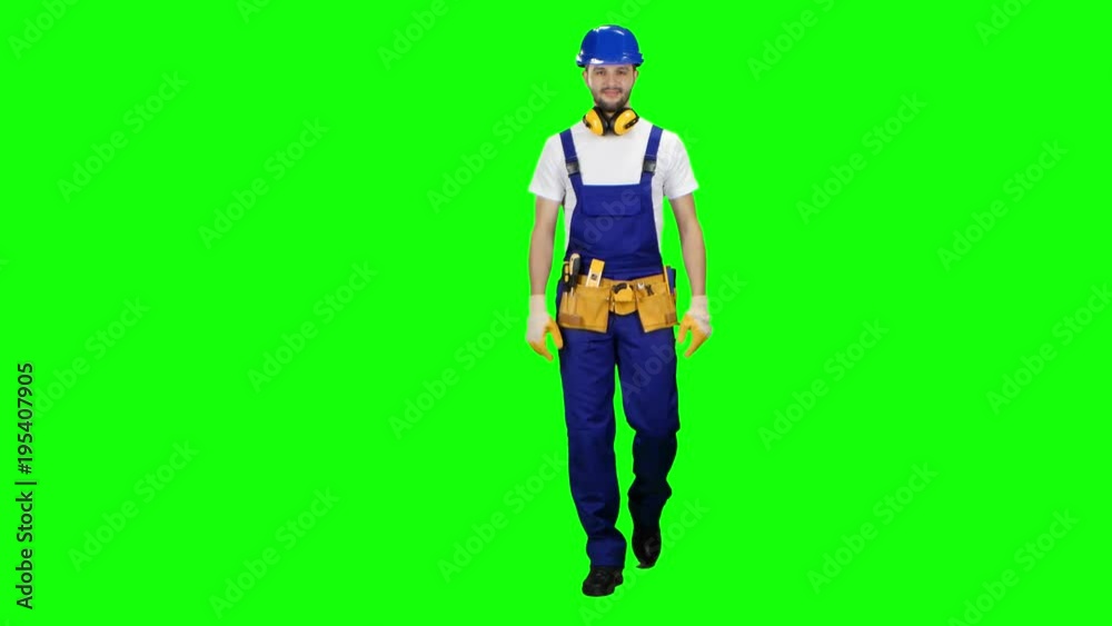 Builder goes to the object with a helmet and tools. Green screen Builder goes to the object with a helmet and tools. Green screen