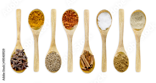 Collection spices on a wooden spoon. isolated on a white background