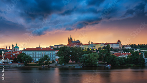 Prague old town including Prague castle in the background, one of the most famous landmarks of Prague at sunset with dramatic sky.