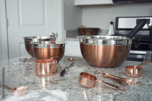 copper metal bowls and cups in kitchen after cooking