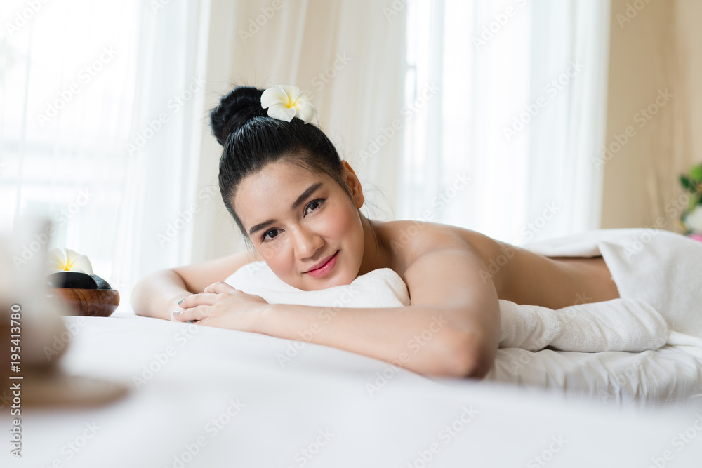 Beautiful Asian girl smile relaxing in the spa massage in salon Beautiful Asian girl smile relaxing in the spa massage in salon