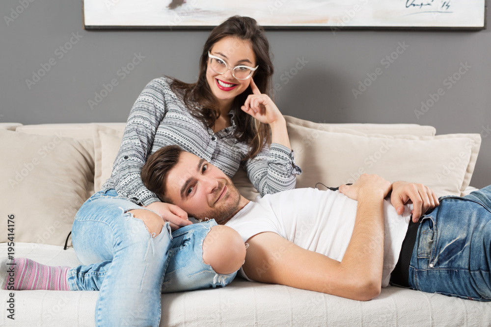 Young cople resting on sofa