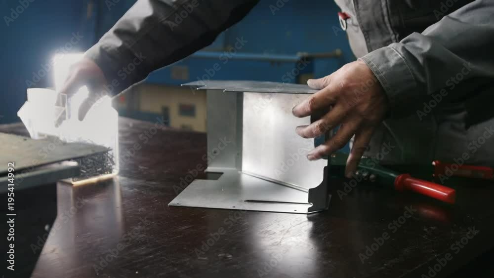 Worker assembling the metal part in the manual