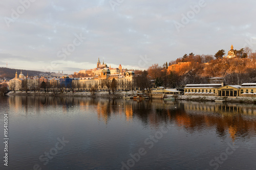 Sunny snowy early morning Prague Lesser Town with gothic Castle above River Vltava, Czech republic © Kajano