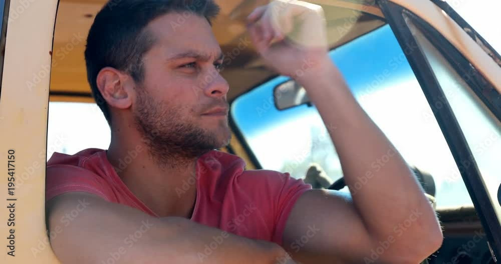 Man sitting in a car on a sunny day Man sitting in a car on a sunny day