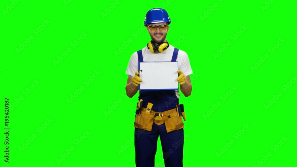 Engineer picks up the paper plate and smiles. Green screen Engineer picks up the paper plate and smiles. Green screen