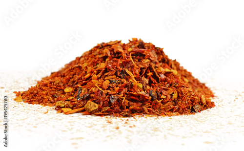 Fototapeta Naklejka Na Ścianę i Meble -  Red chili flakes, ground spice hot pepper isolated on white background