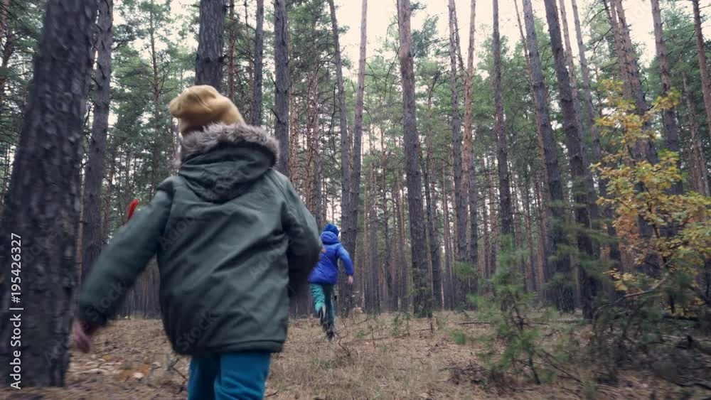 Children running to mother and granny in the forest Children running to mother and granny in the forest