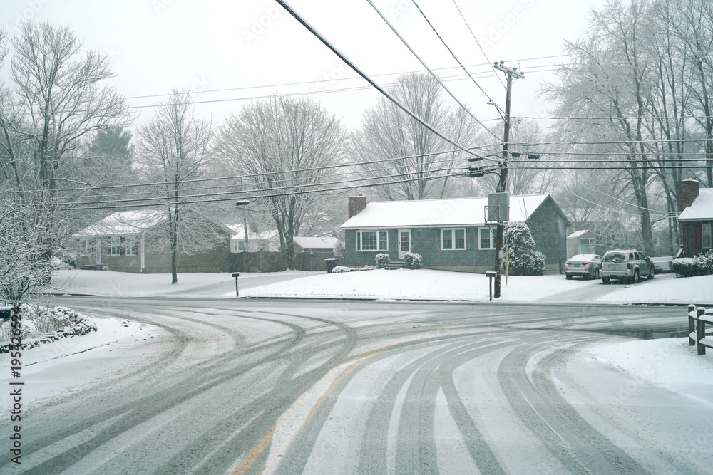 Winter street scene in snow in residential community Winter street scene in snow in residential community