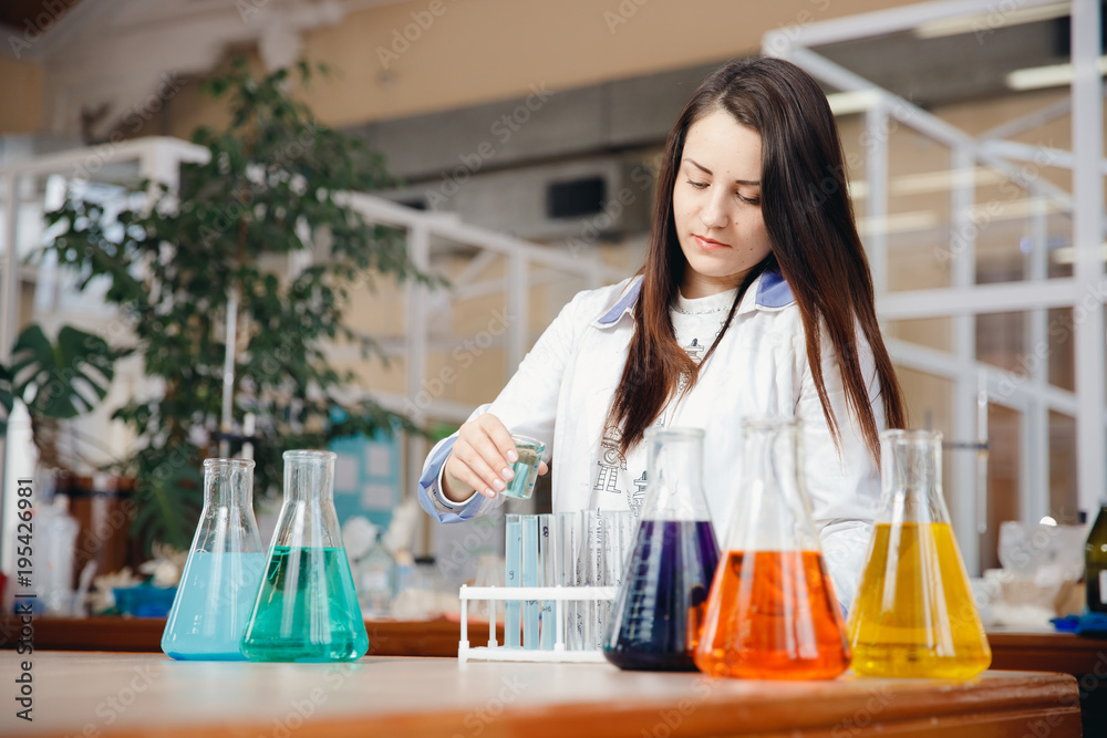 Chemistry worker prepares for an experiment to determine the hardness of water, an analysis of oil. Chemistry worker prepares for an experiment to determine the hardness of water, an analysis of oil.