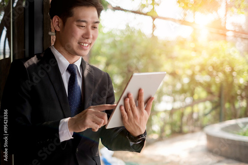 young businessman working with mobile laptop and documentsin office, business concept