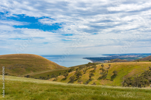 Picturesque view on countryside landscape with hills and sea © Olga K