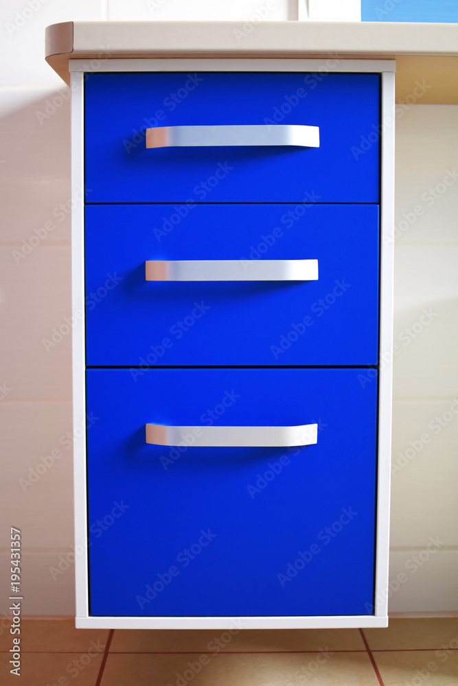 Bright blue modern chest of drawers with three drawers in bathroom. Bright blue modern chest of drawers with three drawers in bathroom.