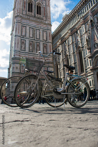 Florence, Tuscany / Italy, - March 8, 2018. Bicycle Parking in Piazza Duomo, opposite the bell tower of the Cathedral