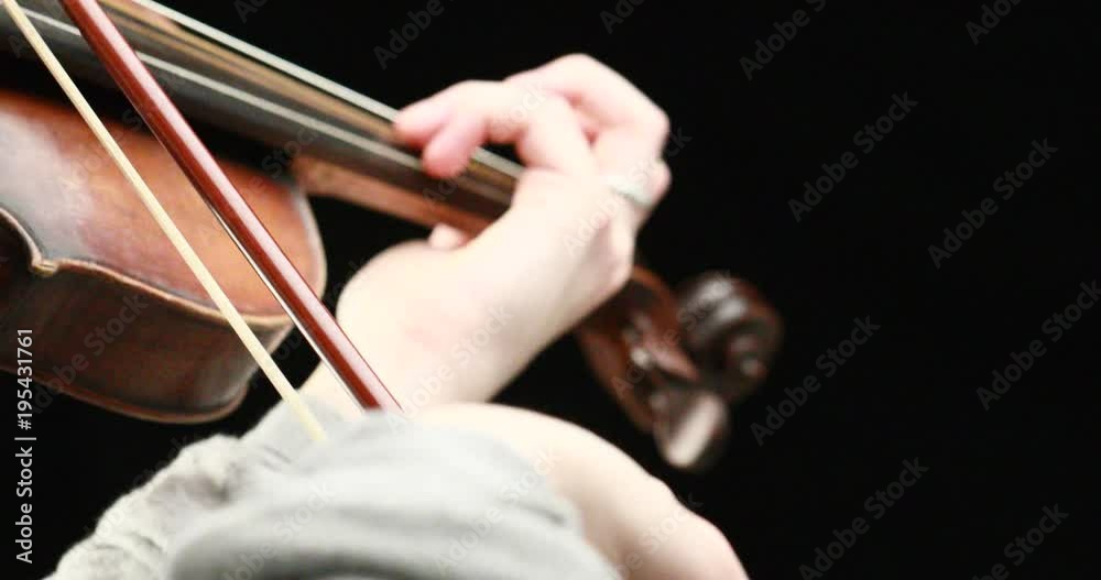 classical musician playing baroque violin on a black background - hands closeup live action concept classical musician playing baroque violin on a black background - hands closeup live action concept