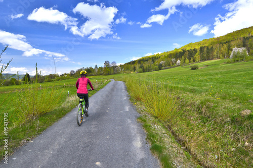 Woman riding a bicycle on a sunny spring day