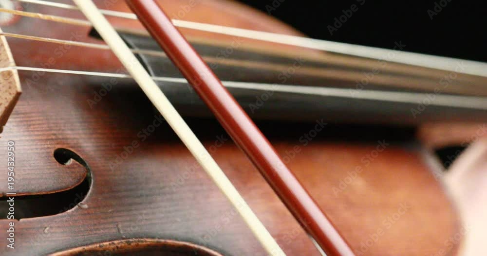classical musician playing baroque violin on a black background - hands closeup live action concept classical musician playing baroque violin on a black background - hands closeup live action concept