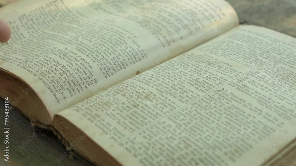 Hand turning the page of the Bible Hand turning the page of the Bible