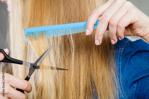 Woman cutting down smoothy hair. photo