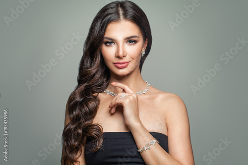 Beautiful Woman with Jewelry Diamond Necklace, Bracelet and Earrings. Perfect Female Face. Woman with Hollywood Wave Hairstyle
