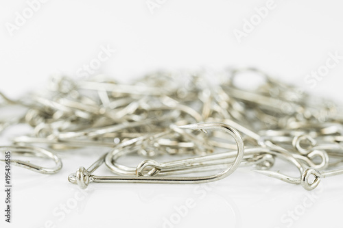 Pile of fish hook on a white