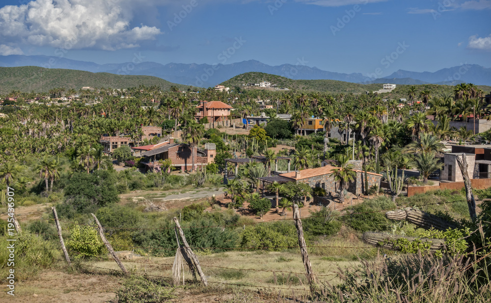 The Hills and Homes of the Village of Todos Santos, Mexico as seen from Above with Distant Mountains