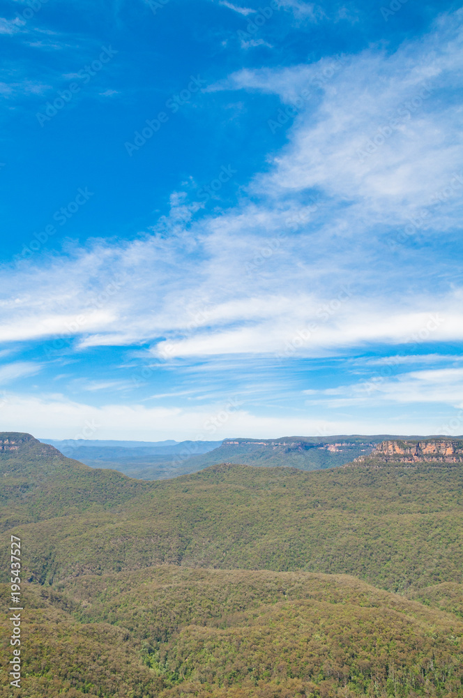 Picturesque landscape of vast eucalyptus forest and mountains under spectacular sky. Blue Mountains, Australia