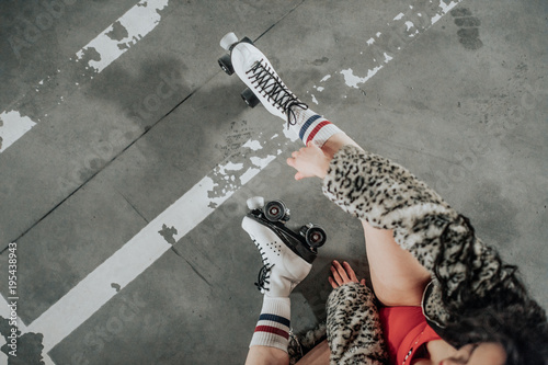 young sexy woman rollerskating in an urban looking garage and posing in a hipster like matter