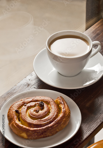 Coffee and bakery in front of the window.