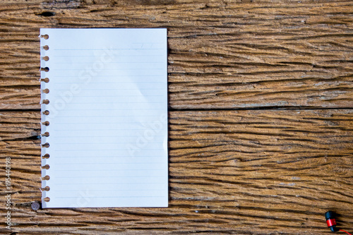 Top view of notebok with pencil, smart phone and calculator on wooden table. Emtry page for text. photo