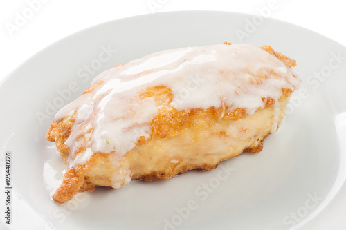 fried fish with sour cream sauce on a plate, white background