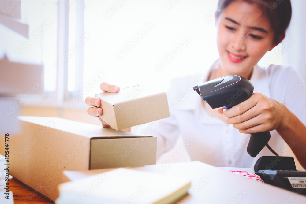 Young asian women holding scanner and scanning barcode with laser at store,Inspection for transport.scan barcodes for sale,online and business concept. Young asian women holding scanner and scanning barcode with laser at store,Inspection for transport.scan barcodes for sale,online and business concept.