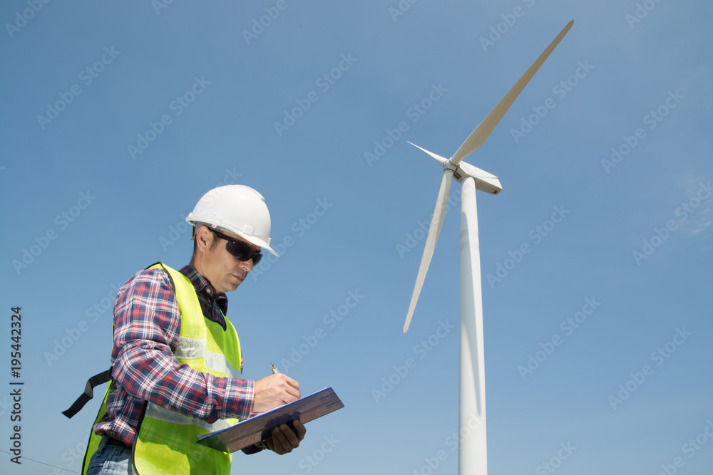 Electric Engineer writing report on Clipboard with Wind turbine power Generator Electric Engineer writing report on Clipboard with Wind turbine power Generator
